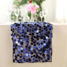 the table cloth has blue sequins on it