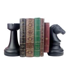 chess pieces and books on a white background