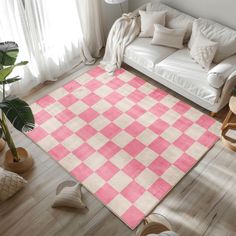 a living room with a white couch and pink checkered area rug on the floor