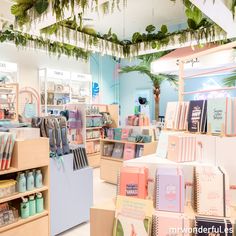 the inside of a store with lots of cards and notebooks on display in it