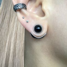 an ear with two black stones on it