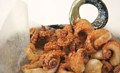 a basket filled with fried food sitting on top of a table