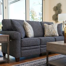 a living room scene with focus on the couch and coffee table in the foreground