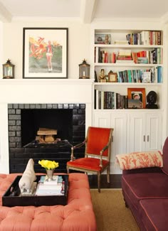 a living room with two couches and a fire place in the middle of it