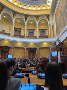 a large room filled with people sitting at desks