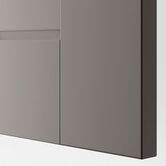 a close up of a gray cabinet with two doors and one door open on the wall