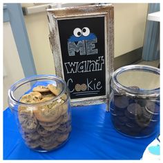 cookie jars filled with cookies sitting on top of a blue table