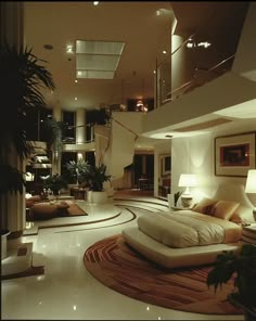 a living room filled with lots of furniture next to a tall ceiling mounted planter