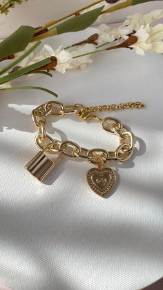 Lock and Heart charm bringing on mind the promises of Eternal Love between each others 𝐌𝐀𝐓𝐄𝐑𝐈𝐀𝐋: 18k Gold plated bracelet 𝐂���𝐀𝐑𝐄 𝐓𝐈𝐏𝐒: Avoid contact with moisture (water, perfume and other chemicals) Mostly take off jewelry when exercising, showering, sleeping When not in use store your pieces in the jewelry bag or box. Water Perfume, Jewelry Bag, Gold Plated Bracelets, Wide Belt, Eternal Love, Jewelry Bags, Care Tips, Heart Charm, Chain Bracelet