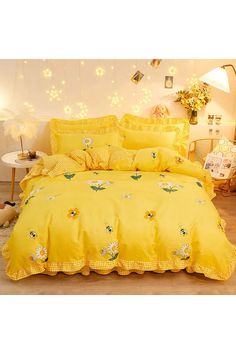 a yellow comforter set with flowers on it