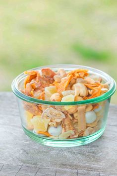 a glass bowl filled with cereal and nuts