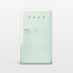 a green refrigerator with the word smeg on it's front and bottom door