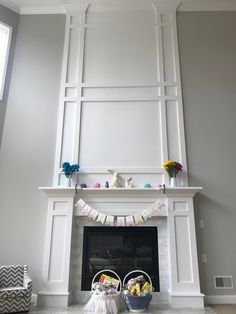 a living room filled with furniture and a fire place covered in buntings next to a fireplace