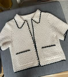 a crocheted shirt sitting on top of a table