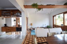 a dining room and living room are separated by an open floor plan with wood trimmings