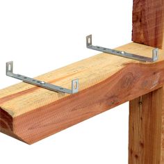 a close up of a wooden rail with metal brackets on it's sides,