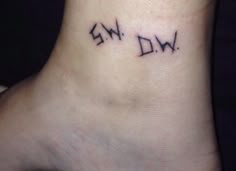 a person with a small tattoo on their foot that says, ew d w