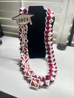 a red and white origami necklace on display