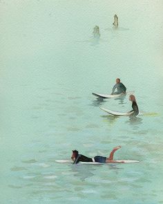 several people in the water on surfboards with one person laying on his back and another standing up