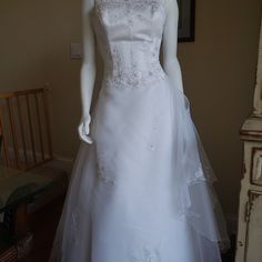 a mannequin dressed in a white wedding dress