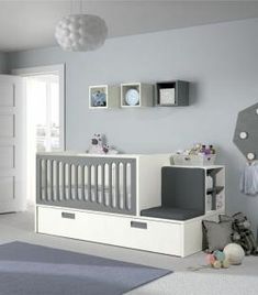 a baby's room with gray and white decor