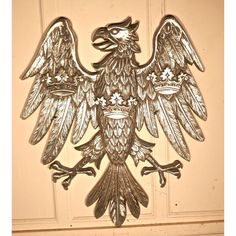 an ornate metal bird on a door