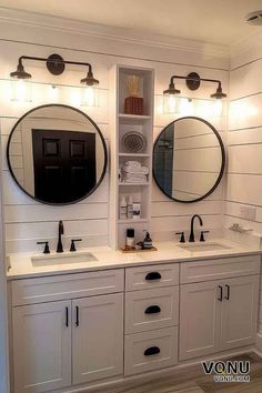 a bathroom with double sinks and two mirrors on the wall next to eachother