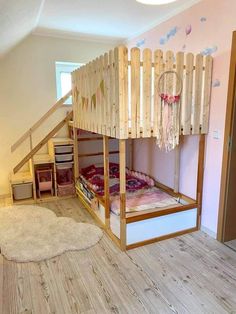 a bunk bed made out of wooden slats in a child's room with stairs