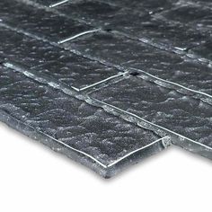 a close up view of a black tile floor