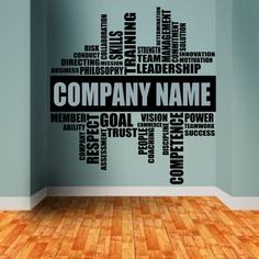 a wall decal with the words company name in black and white, on a wooden floor