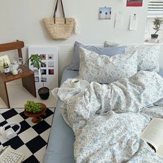 a bed in a room with a checkered floor next to a table and chair