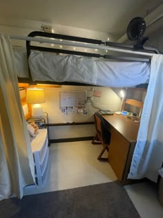 there is a loft bed with a desk and chair in the room next to it