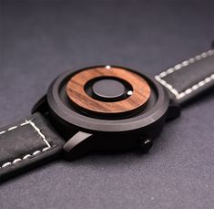 A WATCH THAT LOOKS AND WORKS UNLIKE ANY OTHER. SEE AND FEEL TIME MOVE LIKE NEVER BEFORE THANKS TO OUR REVOLUTIONARY MAGNETIC TECHNOLOGY. UNIQUE, STYLISH AND LUXURIOUS. ALL IN ONE! 100% Real Natural Dark (RECLAIMED) WOOD Wrist Watch. Each Unique Watch is Handcrafted by a Professional Watchmaker. You'll be amazed when you hold a wood watch in your hand or wear it on your wrist since it is really comfortable. High Quality, Luxury Fashion and Stylish with Japanese Movement. It comes with Nice Watch Box. Product Dimensions: Case Diameter 1.77" (4.5 cm) Case Thickness 0.47" (1.2cm) Band Width 1.02" (2.6cm) Band Length 8.66" (22cm) HOW DOES IT WORK? - Each watch features two ball bearings that use magnetized technology to travel around the face of the watch. - One track is featured on the outer e Nice Watch, Great Anniversary Gifts, Wooden Watch, Watches Unique, Groomsmen Gifts, For Him Gifts, Him Gifts, Anniversary Gifts For Him, Watch Box