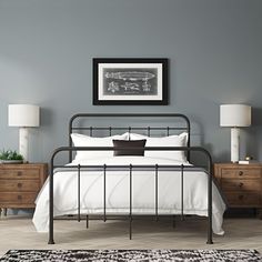 a bedroom with gray walls and white bedding