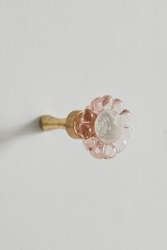 a close up of a ring on a white surface with a flower design in the middle