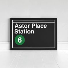 a black and white sign that says aster place station 6