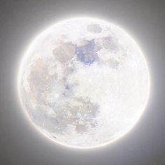 the full moon is visible in the sky with only one light on it's side