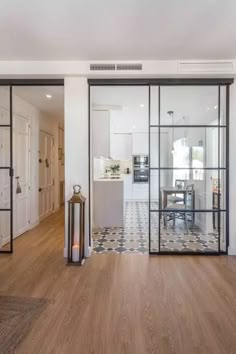 an open living room and dining area with glass doors