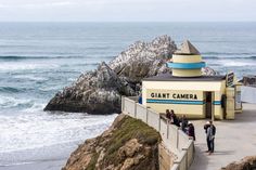 people are standing at the entrance to giant's camera in front of the ocean