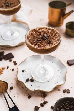 three glasses filled with dessert on top of plates