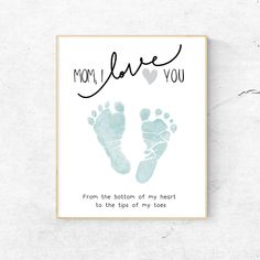 a card with the words mom love you and two baby footprints