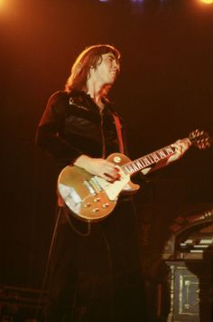 a man playing an electric guitar on stage