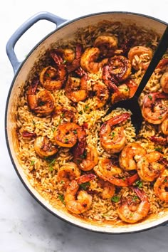 a skillet filled with rice and shrimp