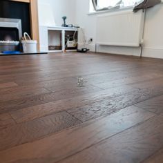 an empty room with wood flooring and a fire place