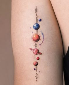 a woman's thigh with planets and stars on it