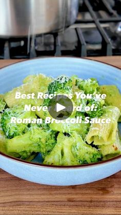 a bowl filled with broccoli on top of a wooden table next to a stove