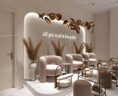 a room with chairs, tables and lights on the wall that says all you need is love