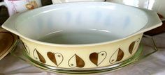 a white bowl sitting on top of a table next to other dishes and utensils