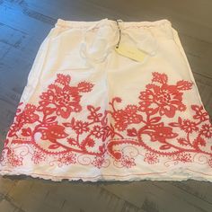 Super Sharp Looking White Skirt With Red Flower Pattern. Fully Lined With Elastic Waist Red Lined Summer Skirt, Red Summer Skirt With Lining, Red Lined Skirt Bottoms For Summer, Red Lined Skirt For Summer, Summer Mini Skirt In Red, Red Mini Skirt For Summer, Red Summer Mini Skirt, Casual Red Bottoms With Floral Embroidery, White Floral Embroidered Skirt