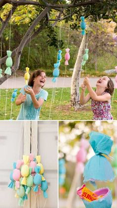 some balloons are hanging in the air and one girl is holding a candy bag while another holds